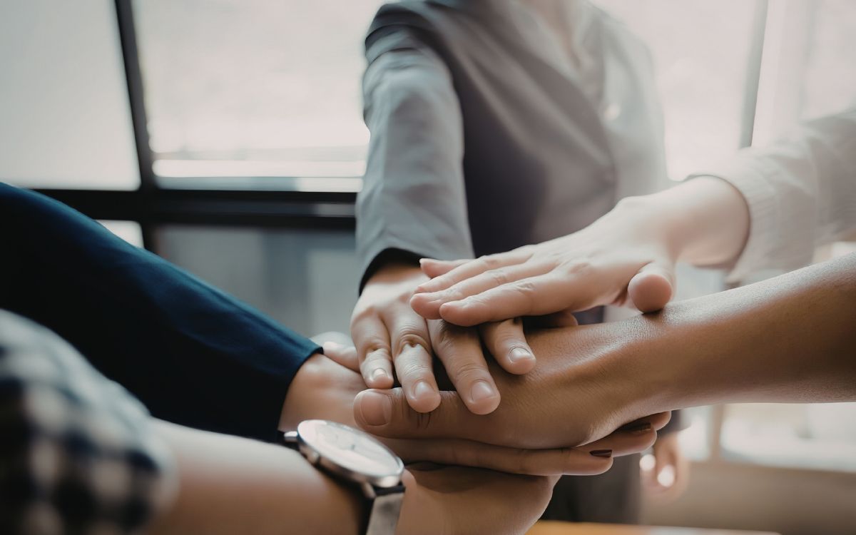 A group clasping hands representing teamwork