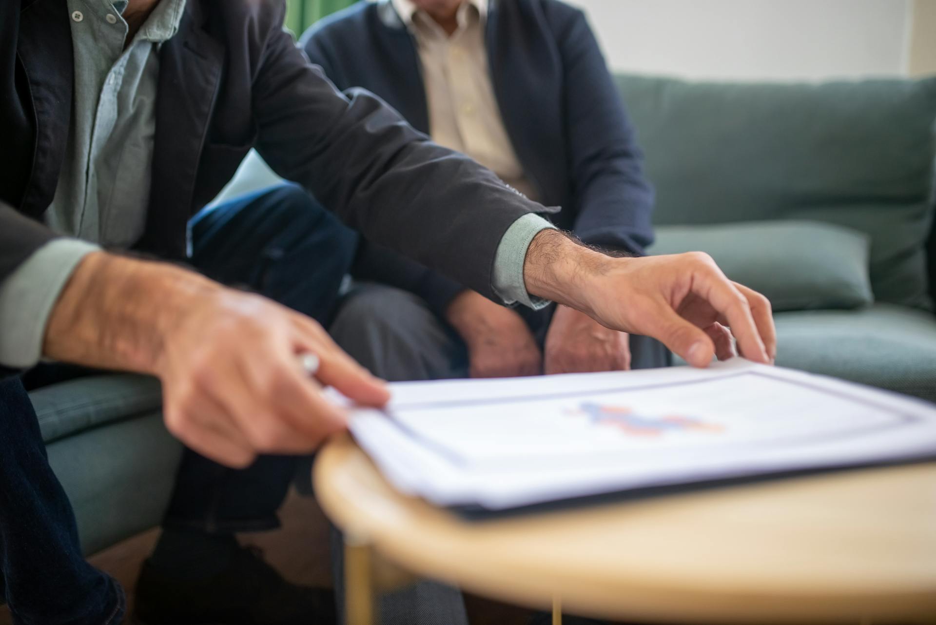 Two people reviewing insurance or healthcare documents together during a consultation.